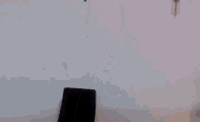 a woman in overalls is dancing in front of a computer screen .