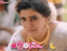 a woman wearing a white saree and gold jewelry with the word black on the bottom right