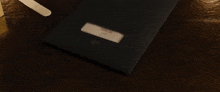a black envelope with a white label that says ' invoice ' on it
