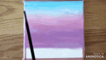 a painting is being painted on a wooden table and the words made in animatica are on the bottom
