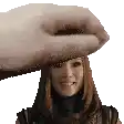 a hand is holding a woman 's head in a pixelated image
