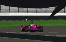 a pink race car is going down a track