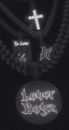 a black and white photo of a lover boyz pendant