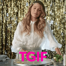 a woman in a white shirt is standing in front of a gold curtain with the word tgif written in pink