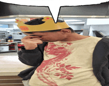 a man wearing a burger king crown covering his face