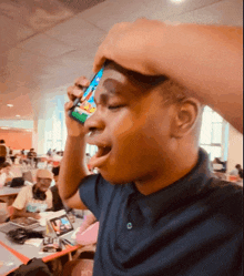a man is talking on a cell phone while holding his head