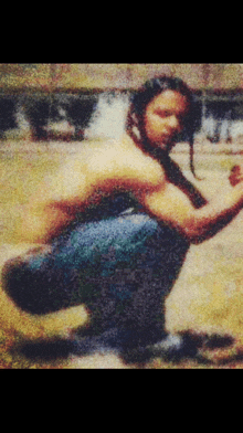 a blurry picture of a man squatting down in a park