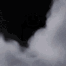smoke is coming out of a hole in the ground on a black background
