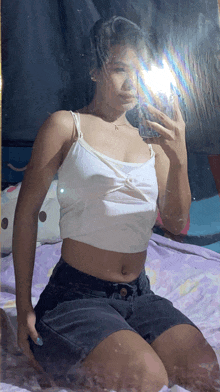 a woman taking a selfie in a mirror with her phone