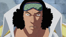 a man with curly hair is wearing a goggles and a white shirt