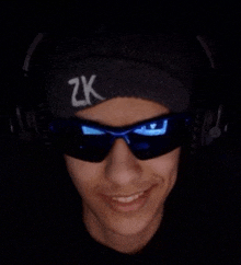 a man wearing headphones and sunglasses with the letter zk on his headband