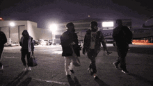 a group of people are walking in front of a plane that says n727lc