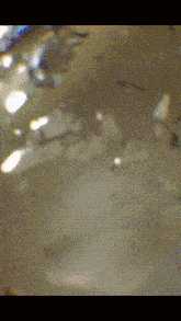 a close up of a blurred image with a few spots of light