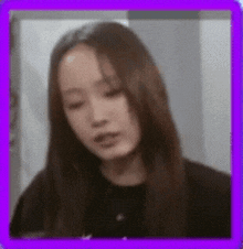 a close up of a woman 's face with a purple border around it