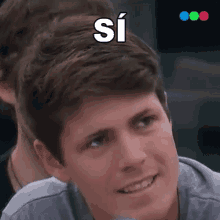 a man with the word si written on his head