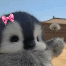 a stuffed animal has a pink bow on its head