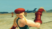 cammy from street fighter is kneeling down in the dirt