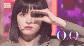 a close up of a woman 's face with a sign that says ' kpop inkigayo ' on the bottom
