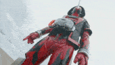 a person in a red and black costume with a helmet
