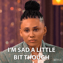 a woman with dreadlocks and a bun says " i 'm sad a little bit though "