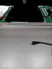 an hp laptop is plugged into a wall with a cable