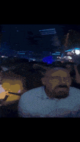 a man with a beard is sitting in front of a crowd with a sign that says tas
