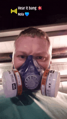 a man wearing a gas mask with the words hear it bang nola on the bottom