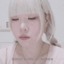a girl with white hair and a necklace is touching her hair