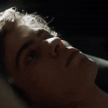 a close up of a man 's face with the sun shining on his face