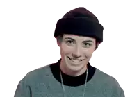a woman wearing a beanie and a sweater smiles
