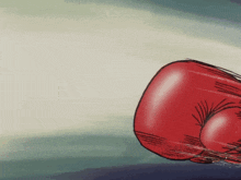 a close up of a red boxing glove on a blue surface