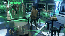 a group of people are dancing in a room with a sign that says " a fazenda "