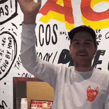 a man wearing a white shirt that says dingo on it