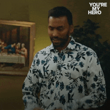 a man in a floral shirt with the words you 're my hero on the bottom