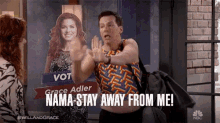 a man is standing in front of a poster for grace adler