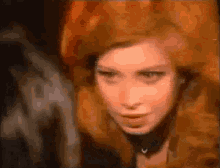 a close up of a woman with red hair