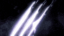a purple light beam is coming out of a dark background .