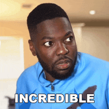 a man in a blue shirt has the word incredible written on his chest