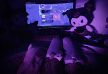a person sitting in front of a computer with a purple background