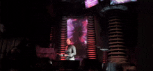 a woman is standing in front of a screen that says " silence creature "