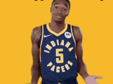 a basketball player for the indiana pacers is standing with his hands outstretched