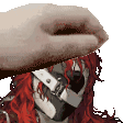 a hand is covering a person 's face with a glove .