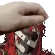a hand is covering a person 's face with a glove .