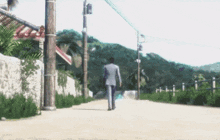 a man in a suit is walking down a street