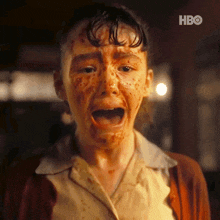 a close up of a person with blood on their face with the hbo logo in the corner