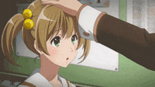 a person touching a girl 's head with a yellow ribbon
