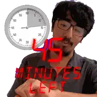 a man with glasses and a clock behind him that says 45 minutes left on it
