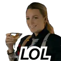 a woman is smiling while holding a martini glass and the word lol is behind her