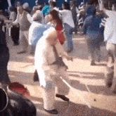 a group of people are dancing on a dance floor in a room .