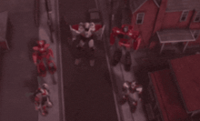 a group of robots are walking down a street in a city